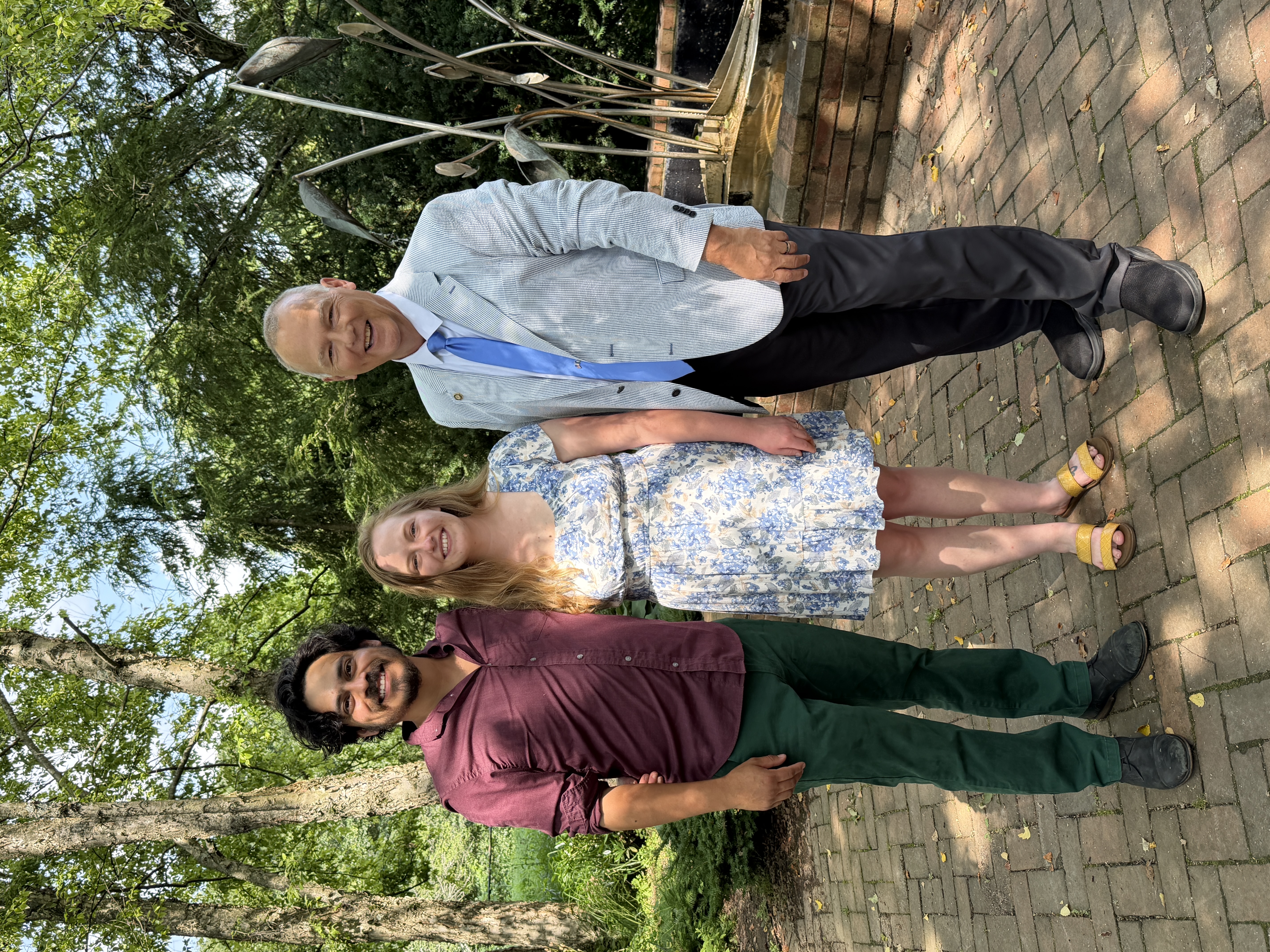 Kevin with newlywed couple in garden setting