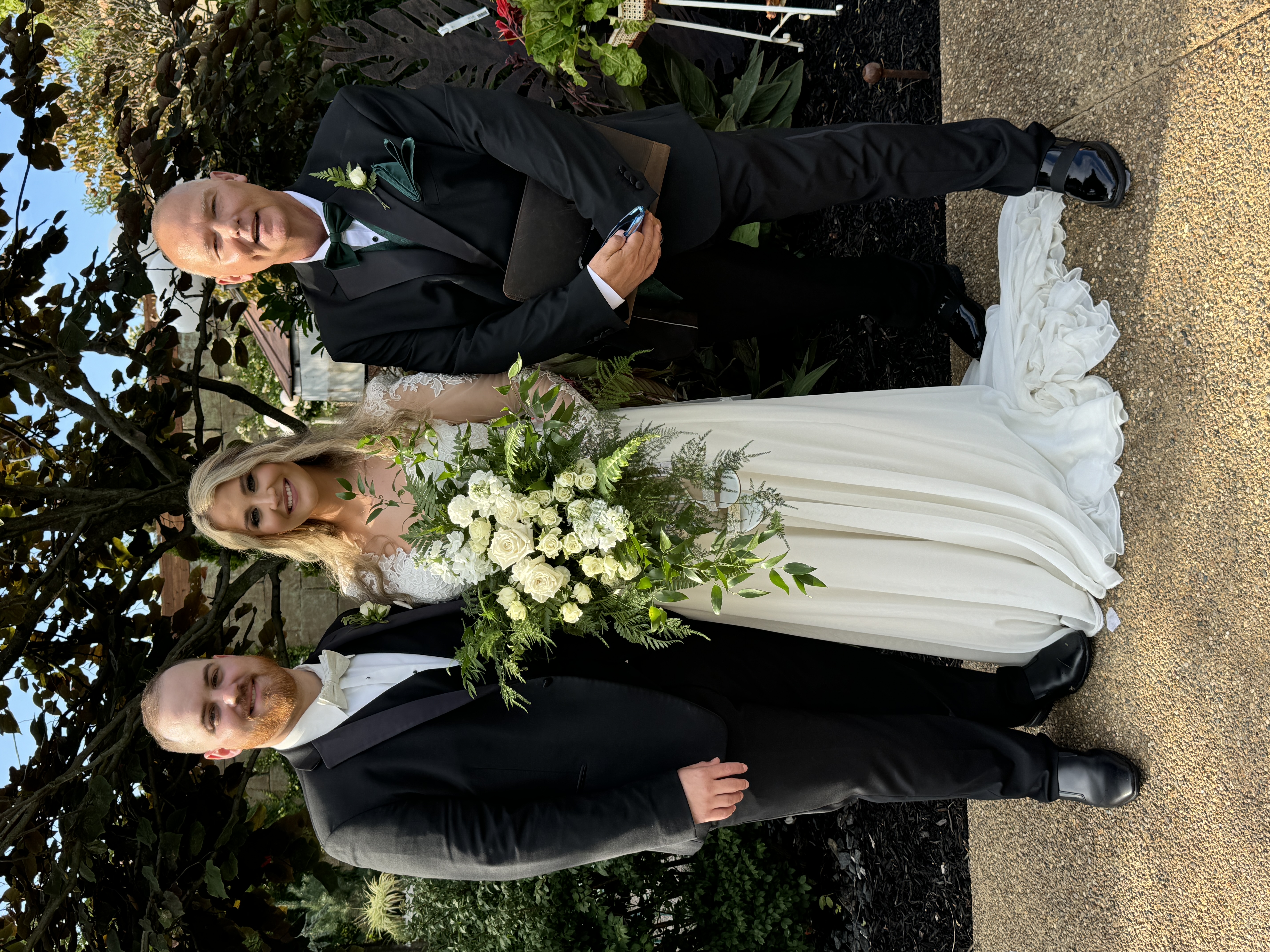 Kevin with couple outdoors after ceremony